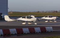 G-CFJO @ EGSH - Pair of DA40's sat on stand at SaxonAir. - by Matt Varley