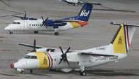 C-GPAB @ TNCM - side by side goes the dash 8's