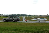 OY-KKX @ EKRK - A LAK-17AT motorglider being towed by a Volvo at Roskilde airport. This aircraft is Lithuanian designed and built and has a small retractable engine.