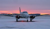 N95LL @ KAXN - Beech 65-A80 Queen Air from Bemidji Aviation Services sitting on the ramp as the January sun sets. - by Kreg Anderson