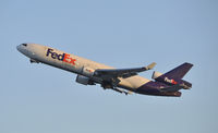 N603FE @ KLAX - Departing on 25R - by Todd Royer