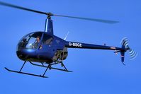 G-BSCE @ BREIGHTON - The R22 easing down to terra firma and a soft landing - by glider