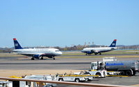 N710UW @ KDCA - Taxi DCA, VA WITH N764US in the back ground - by Ronald Barker