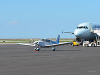 N4478T @ BKL - N4478T seen parked in front of the Blue Jays' charter plane, Air Canada's C-FPWE. - by aeroplanepics0112
