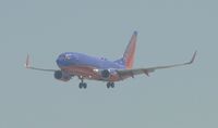 N442WN @ ONT - Coming out of the haze on final for 26R - by Helicopterfriend