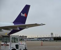 N731FD @ CLE - The tail of N731FD and a view of Concourse D, the parking garage and the Sheraton at the airport. - by aeroplanepics0112
