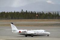 C-FAPK @ CYXY - On the ramp at Whitehorse during a Spring snowstorm. - by Murray Lundberg