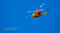 VH-HRS - Westpac 1 Rescue Helicopter banks into a clear blue sky above its headquarters in Broadmeadow, NSW, Australia