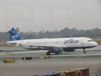 N580JB @ LAX - Taxiing to 24L - by Helicopterfriend