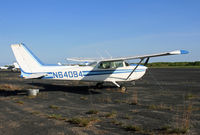 N64094 @ KBLM - With flattened tires and a missing nosewheel, this poor Skyhawk looks like she has been sitting on this weed-choked lot for a while. - by Daniel L. Berek