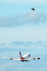 VH-OQB @ YSSY - The chopper was equipped with an external camera and followed the entire take-off run and take-off right above the A380. Exciting to watch... - by Micha Lueck