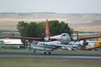 N285 @ BIL - Cessna 337 dwarfed by a Neptune tanker.