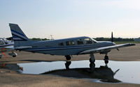 N8403B @ BLM - A 1981 Piper Saratoga makes a nice reflection in a recent rain puddle. - by Daniel L. Berek
