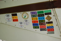 G-BIAP @ EICL - Badges of honour on the door of this PA-16