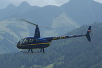 OE-XHK @ LOWZ - The four persons Robinson helicopter is landing direct on the Helicopter apron at Zell am See.