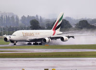 A6-EDQ @ EHAM - Landing on runway 27 of Amsterdam Airport with the two inside engines in reverse on a rainy day - by Willem Göebel