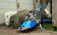 G-JRKD @ EGLS - The wreck of the Airvan (G-CDYA) is under the canvas and the wings of it are propped-up against the hangar.
If you look to the left of the trailer, you'll see the remains of a dark-blue giro-copter.