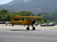 N69765 @ SZP - 1941 Boeing Stearman A75N1 as Navy N2S1, Continental W670 220 Hp, landing roll Rwy 22. This plane occasionally easily takes off using the last third of Rwy 22 - by Doug Robertson