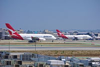 VH-OQI @ KLAX - ATC advised Qantas A380 to hold on Rwy 25R while company 747 was leaving gate.  Landing traffic still operational on Rwy 25L.