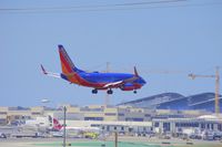 N436WN @ KLAX - Southwest 737 on on approach with Tom Bradley construction in background. - by speedbrds