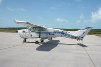 N9486T @ ILG - A white Cessna 210 with blue trim that has sustained serious damage after stalling. The tail has hit the ground. Nobody was injured. The aircraft was never restored. - by NitroPlanes