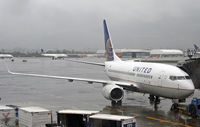 N23708 @ KEWR - A United 737-700 waits out a downpour at Newark Liberty International Airport. - by Daniel L. Berek