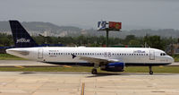 N554JB @ TJSJ - Sacre Bleu taxies past the main terminal at San Juan. - by Daniel L. Berek