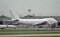 N790CK @ KEWR - A classic 747 freighter is surrounded by goods on the far side of the Newark ramp.  This Jumbo was built in 1984 for Northwest. - by Daniel L. Berek