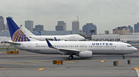 N76529 @ KEWR - A United 737-800 heads out for the crowded Newark ramp after being delayed by severe local weather. - by Daniel L. Berek