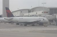 N337NW @ DTW - Delta A320 at McNamara Terminal - taken out of the hazed window of a US Airways A319