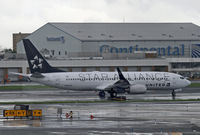 N26210 @ KEWR - I caught the UA Star Alliance Boeing 737 on a very wet day in Newark.  Note the old Continental name on the freight building in the background. - by Daniel L. Berek