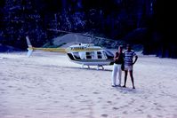 N16663 - The pilot then landed N16663 on a beach on the Na Pali Coast where he took this photo of us in front of the helicopter.  He gave us 5 minutes to visit a waterfall after which we took off to resume the tour. - by The Pilot