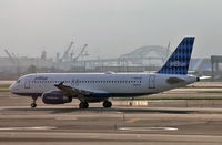 N509JB @ KEWR - True Blue shows her colors on a hazy summer day after a thunderstorm. - by Daniel L. Berek