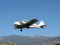 N2291P @ SZP - 1957 Piper PA-23-150 APACHE, two Lycoming O-320s 150 Hp each. Takeoff climb Rwy 22. Hines Peak at 6.704' in background. Highest mountain in Ventura County is Mt. Pinos at 8,831'. - by Doug Robertson