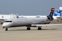 N933LR @ KSRQ - US Air Flight 2678 operated by Mesa (N933LR) prepares for flight at Sarasota-Bradenton International Airport - by Jim Donten
