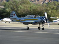N6294D @ SZP - 1983 Yakovlev YAK 52, Vedeneev (Ivchenko) M-14P 360 Hp, this aircraft has pneumatic air high-pressure bottle for engine start, gear retraction/extension and flaps charged by M-14P engine pump, landing roll Rwy 22.  - by Doug Robertson