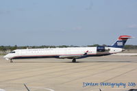 N931LR @ KSRQ - US Air Flight 2678 operated by Mesa (N931LR) prepares for flight at Sarasota-Bradenton International Airport - by Donten Photography