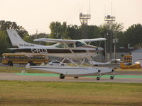 C-FLLO @ KOSH - Cessna 182 Sealane landing at Oshkosh - by steveowen