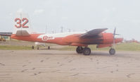 C-GHLX @ CYXJ - One of at least four Con Air aircraft fighting forest fires in northern Alberta, August 1981. Note heavy smoke. - by Nigel Hannaford