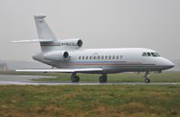 M-FALC @ EGHH - Departing in pouring rain - by John Coates