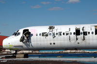 SE-RDR @ ESSP - MD-82 in derelict state at Norrköping Kungsängen airport, Sweden. It is being used as a source for spares and to be scrapped. Note the graffiti on its nose.