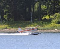 N91475 - Taking off in front of an old cemetery at Hoonah, Alaska. - by Murray Lundberg