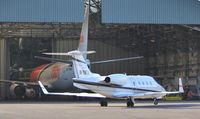 M-TNTJ @ EGHH - Crew arriving for OO-TNQ, still in service bay - by John Coates