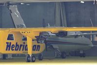 M-FRED @ EGHH - ex D-IXIE just entered paintshop, behind Islander G-HEBO being finished off. - by John Coates