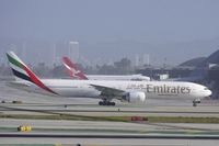 A6-ECK @ KLAX - Emirates 77W taxiing to TBIT whilst Qantas Airways A388 is docked at the new TBIT gates.