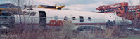 N148PE - N148PE sits heavily stripped in the early spring overcast, inside the yard of a crane operator in Golden Valley, MN. Early to mid 1990's. Due to a huge mud puddle I could not take the shot any closer. - by Vaughn Hangartner