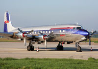 N996DM @ LOWG - Red Bull DC-6 in the morning sun.