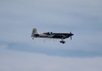 N821MG - Mike Goulian Extra 300S over Cocoa Beach - by Florida Metal