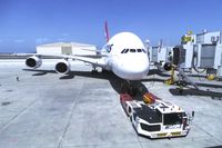 VH-OQI @ KLAX - Qantas David Warren A380-842 taken from inside the new Tom Bradley International Terminal on LAX Appreciation Day at Gate 150 with tug at the ready.  Take note of the 3 jet bridges.