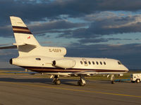 C-GGFP @ CYXR - This nice bizjet looked cool as it was being pushed into its hangar for the night after landing at sunset. - by Chris Coates